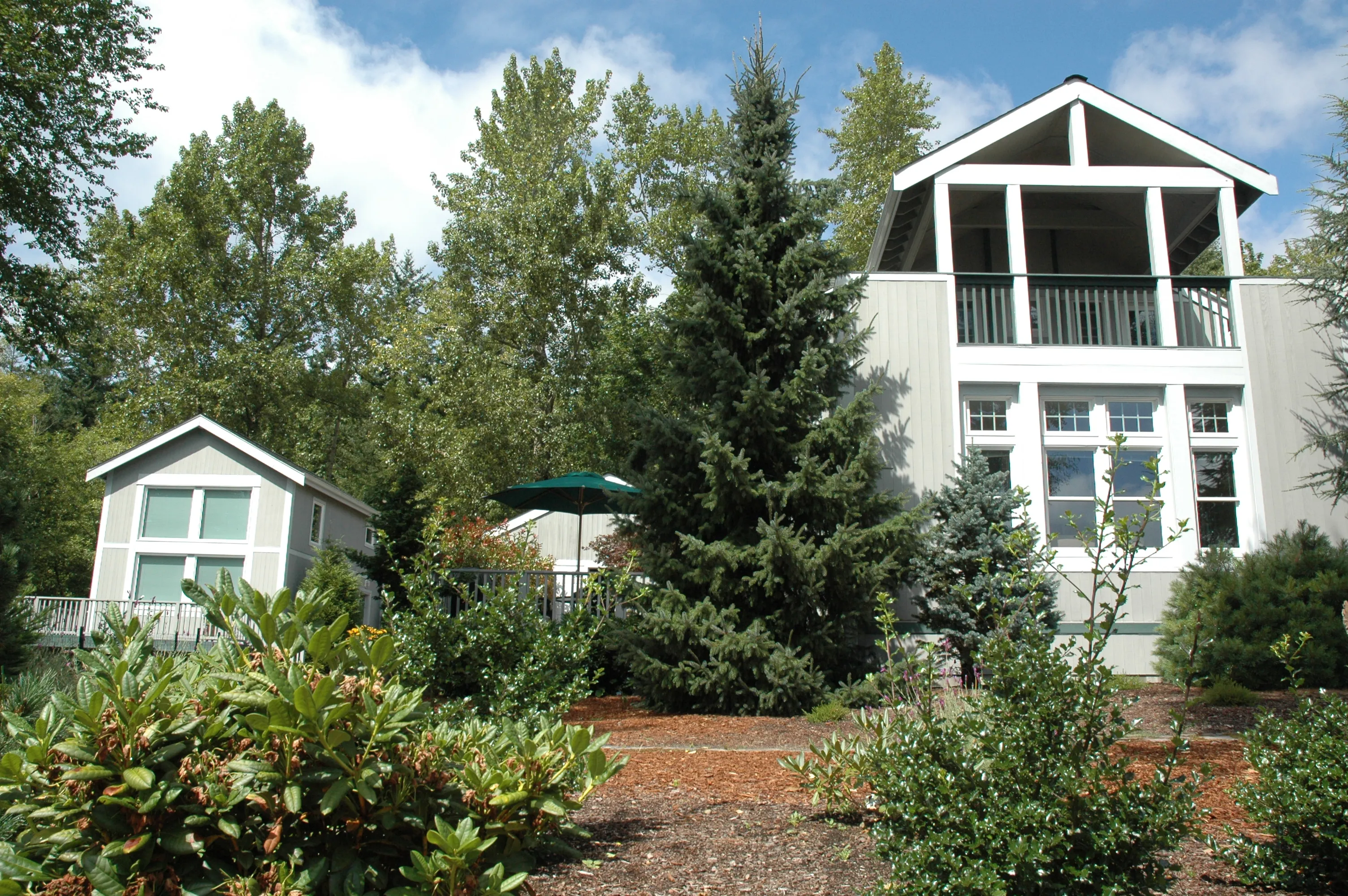Rear exterior view of the home's grounds and landscaped garden path.